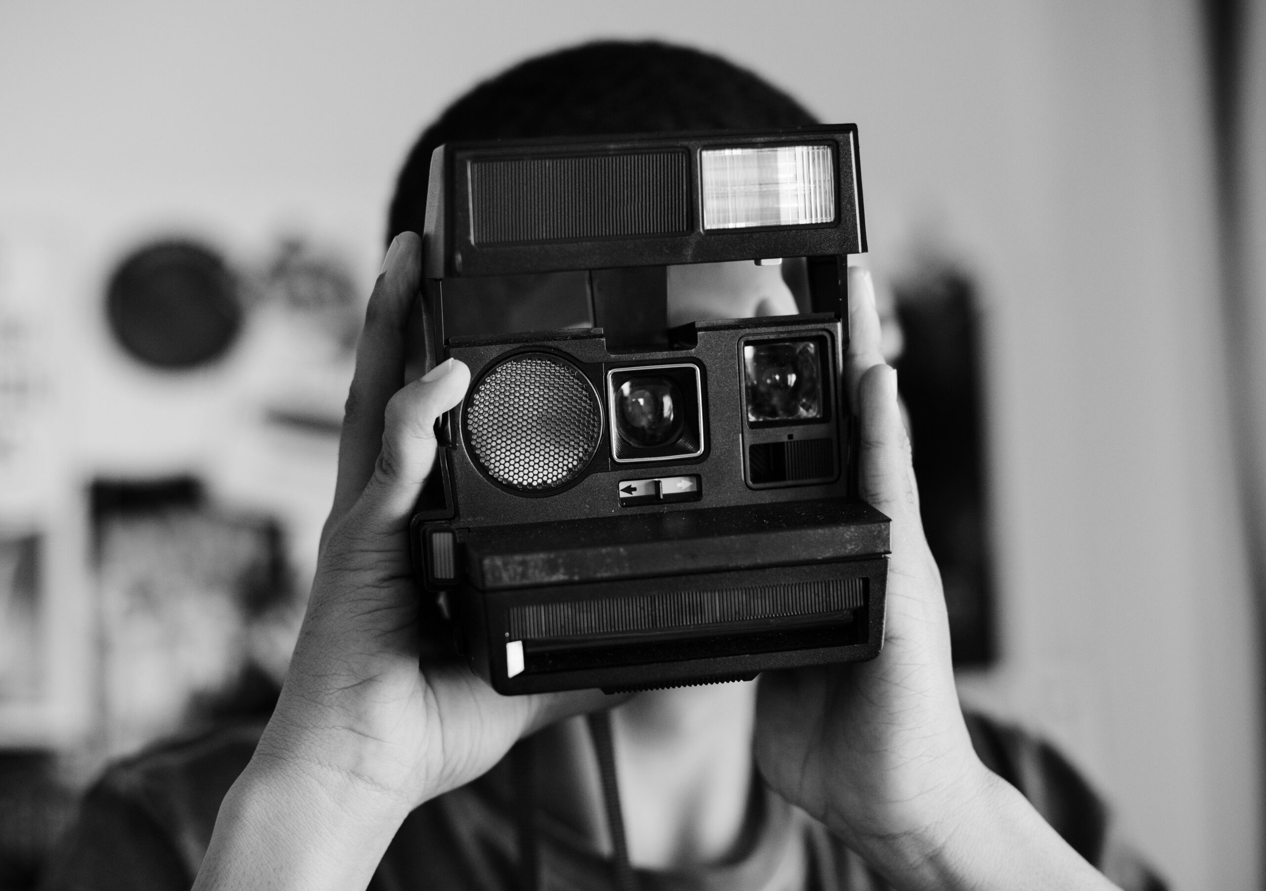 Teenage boy taking a picture in a bedroom hobby and photography concept