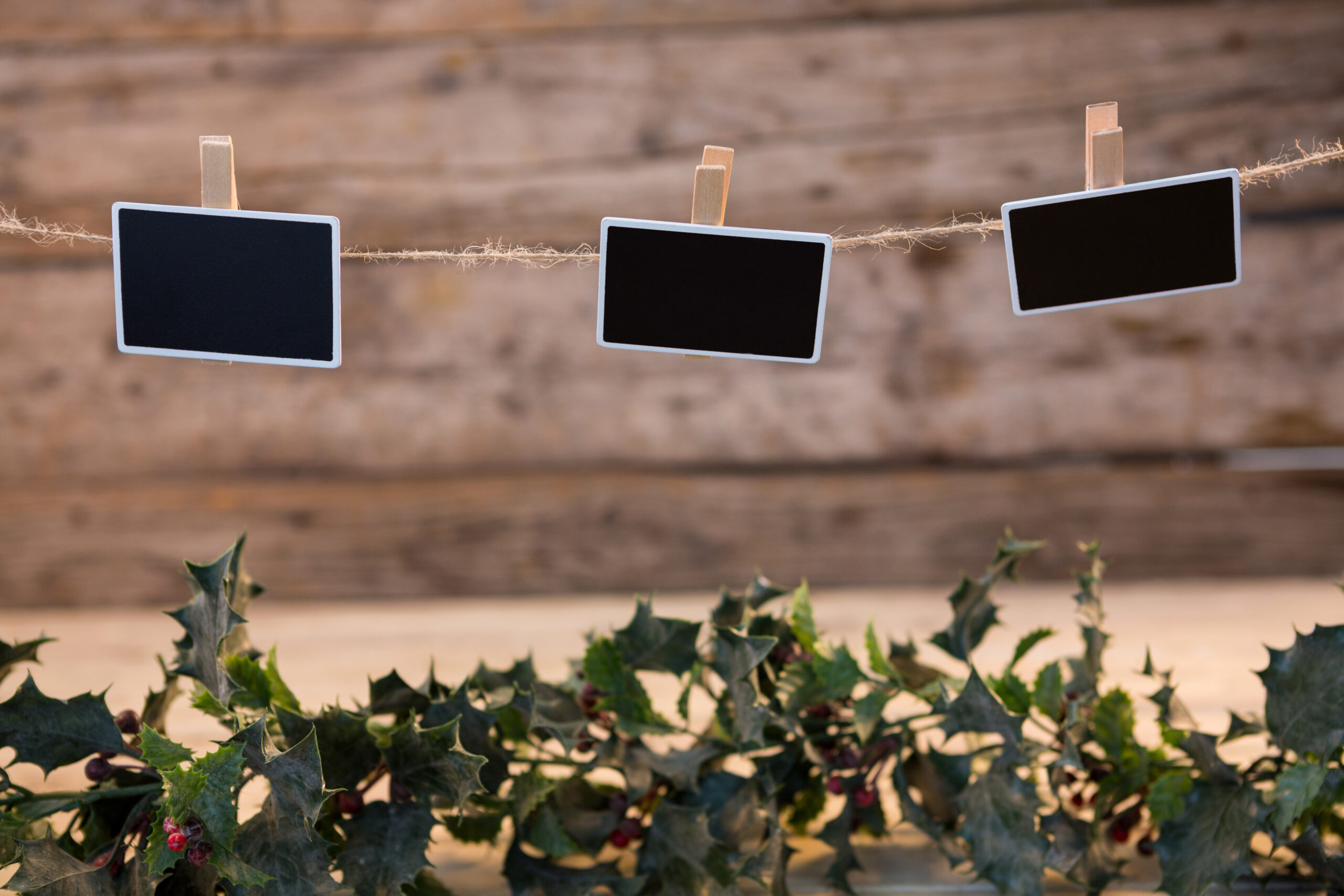 Christmas decorations hanging against wooden wall during christmas time